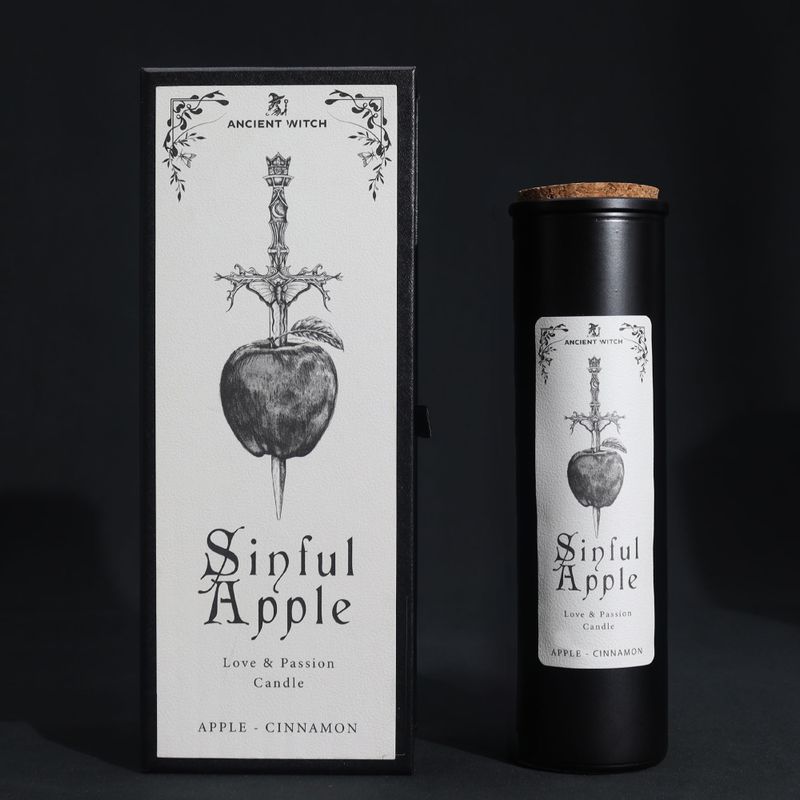 Sinful Apple ritual candle and athame-pierced apple gift box on a black background